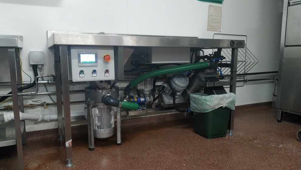 a picture of a bespoke made dehydra food waste dewatering system installed in a hospital kitchen
