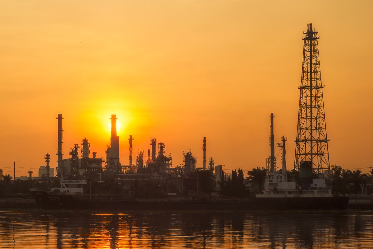 a picture taken at sunset of an oil refinery